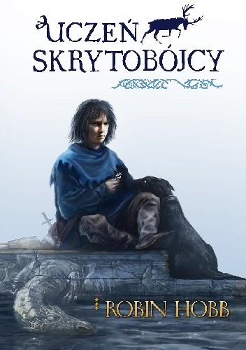 Uczeń skrytobójcy Robin Hobb - okładka przedstawia chłopca z psem, utrzymana w niebieskich barwach