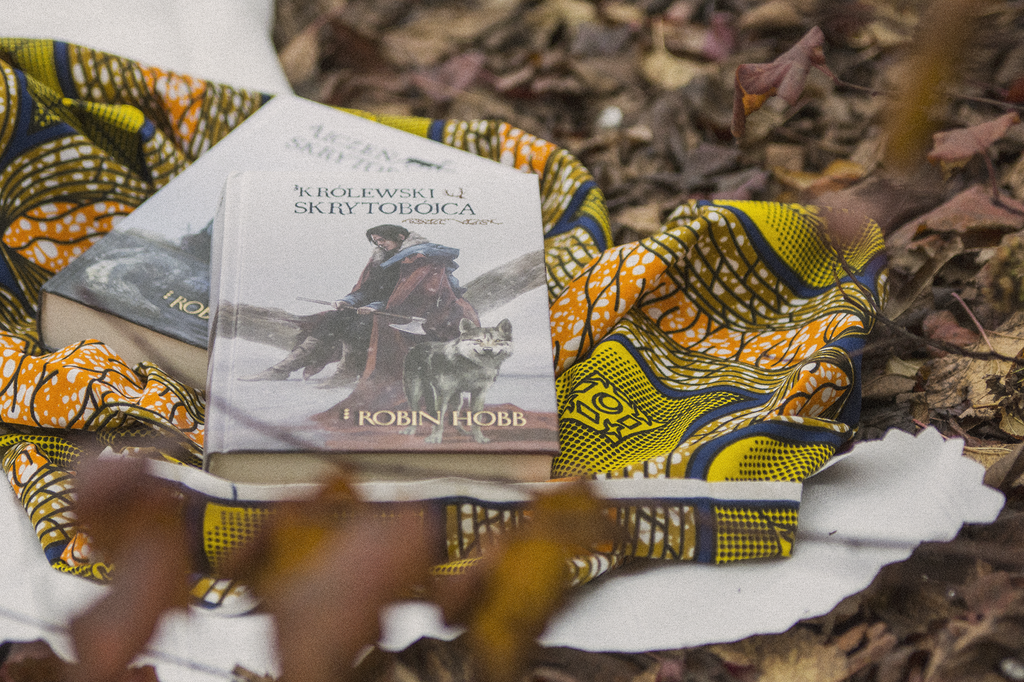 Królewski skrytobójca Robin Hobb - książka leży na dworze, na zewnątrz trwa jesień